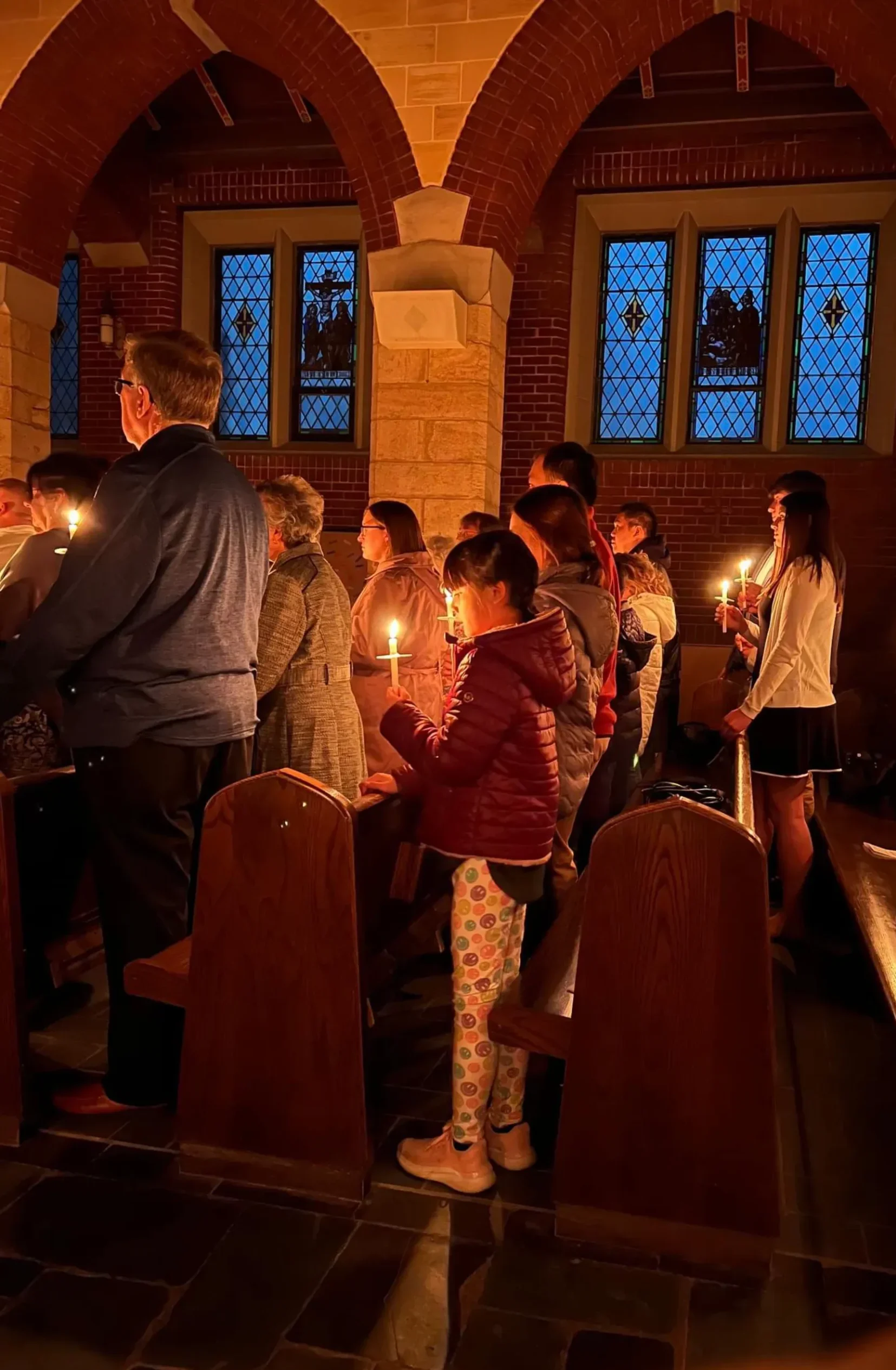 Parishioners holding lit candles
