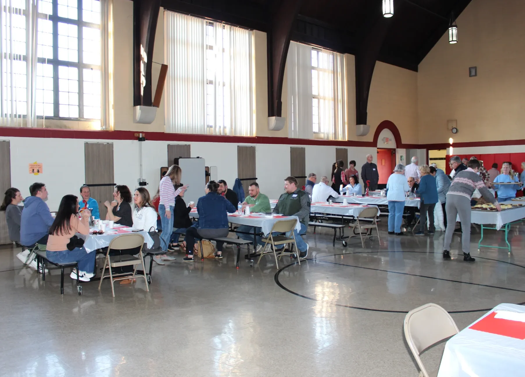 several tables of people eating together