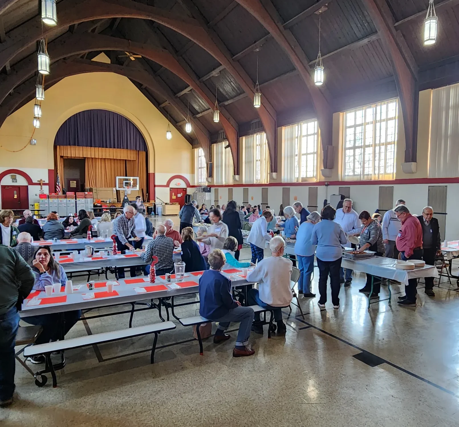 several tables of people eating together
