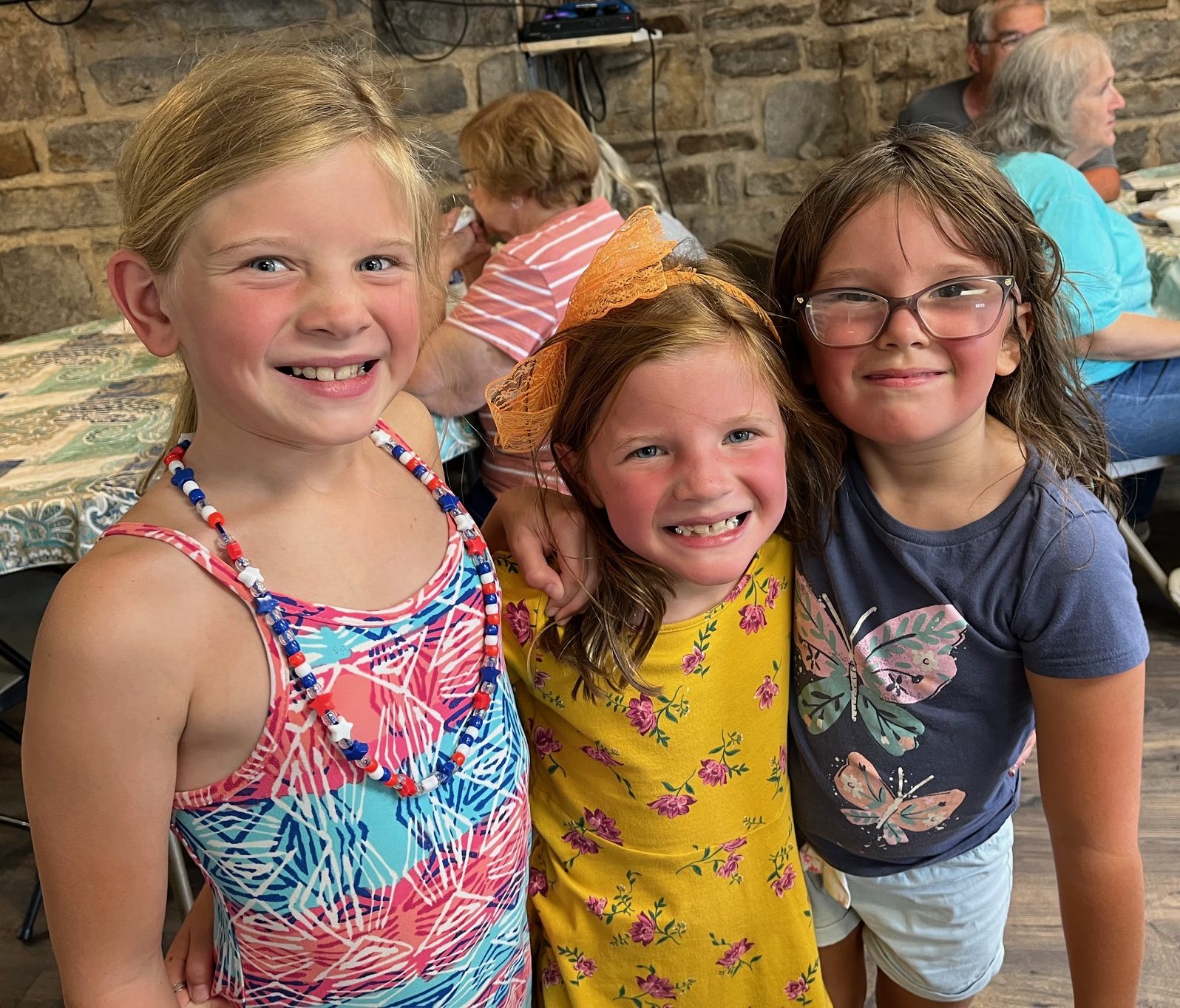 Three children smiling